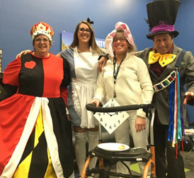 Four sqm staff dressed up for Halloween as Alice in Wonderland